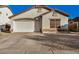 One-story home with a white garage door and stone accents at 12810 W Edgemont Ave, Avondale, AZ 85392