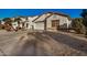 House exterior featuring a two-car garage and desert landscaping at 12810 W Edgemont Ave, Avondale, AZ 85392