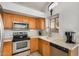 Kitchen area with stainless steel appliances and wood cabinets at 12810 W Edgemont Ave, Avondale, AZ 85392