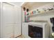 Bright laundry room with washer, dryer and storage shelves at 12810 W Edgemont Ave, Avondale, AZ 85392