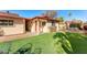 Backyard view with a detached building and grassy area at 13601 N 50Th Pl, Scottsdale, AZ 85254