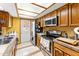 Galley-style kitchen with stainless steel appliances and wood cabinets at 13601 N 50Th Pl, Scottsdale, AZ 85254