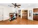 Home office with built-in shelving and hardwood floors at 13601 N 50Th Pl, Scottsdale, AZ 85254