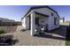 Covered patio with seating area, adjacent to a grassy backyard at 13658 W Sandridge Dr, Sun City West, AZ 85375