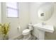 Small bathroom with pedestal sink and toilet at 13658 W Sandridge Dr, Sun City West, AZ 85375