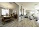 Open dining room with wooden table and chairs, adjacent to living area at 13658 W Sandridge Dr, Sun City West, AZ 85375