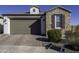 Single story home with stone facade and two car garage at 13658 W Sandridge Dr, Sun City West, AZ 85375