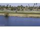 Scenic golf course view with lake and palm trees at 13658 W Sandridge Dr, Sun City West, AZ 85375