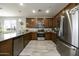 Modern kitchen with wood cabinets and granite countertops at 13658 W Sandridge Dr, Sun City West, AZ 85375