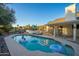 Backyard features a refreshing pool with inflatable floats and lounge chairs at 15201 N 61St Ave, Glendale, AZ 85306