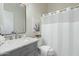 Modern bathroom with gray vanity, marble countertop, and white shower curtain at 15201 N 61St Ave, Glendale, AZ 85306