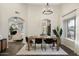 Bright dining room with a farmhouse table and access to the living room at 15201 N 61St Ave, Glendale, AZ 85306