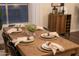 Elegant dining room with a wooden table and place settings at 15201 N 61St Ave, Glendale, AZ 85306