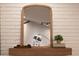 Entryway features a wooden shelf with decorative items and a large arched mirror at 15201 N 61St Ave, Glendale, AZ 85306