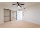 Bedroom with mirrored closet doors and ceiling fan at 1722 Leisure World --, Mesa, AZ 85206