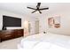 Main bedroom with ensuite bathroom, dresser, and ceiling fan at 1722 Leisure World --, Mesa, AZ 85206