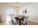 Elegant dining room featuring a wood table and six chairs, with an arched entryway at 1722 Leisure World --, Mesa, AZ 85206