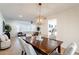 Bright dining room with wooden table and seating, adjacent to living room and kitchen at 1722 Leisure World --, Mesa, AZ 85206