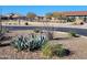 Canyon Park's picnic tables, playground, and covered structure surrounded by lush desert landscaping at 17852 W Country Club Ter, Surprise, AZ 85387