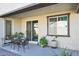 Covered patio with seating area and potted plants at 17852 W Country Club Ter, Surprise, AZ 85387