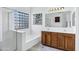 Bathroom with double vanity, soaking tub, and a walk-in shower at 1803 N Desert Willow St, Casa Grande, AZ 85122