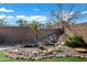 Landscaped backyard with pond and waterfall feature at 1803 N Desert Willow St, Casa Grande, AZ 85122