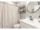 Nicely decorated bathroom with a round mirror, vanity and open shelving at 1814 W Desert Spring Way, San Tan Valley, AZ 85144