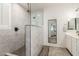 Modern bathroom features glass enclosed shower with tile surround and gray tile flooring at 1814 W Desert Spring Way, San Tan Valley, AZ 85144