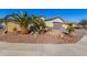 Charming home featuring desert landscaping, a quaint palm tree, and a concrete driveway at 1814 W Desert Spring Way, San Tan Valley, AZ 85144