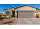 Charming single-story home featuring a two-car garage and low maintenance desert landscaping at 1814 W Desert Spring Way, San Tan Valley, AZ 85144