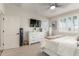 Bright bedroom features a flat screen television, large window and white dresser at 1814 W Desert Spring Way, San Tan Valley, AZ 85144