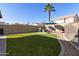 Landscaped backyard with artificial turf and fire pit at 1918 E Saratoga St, Gilbert, AZ 85296