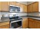 Kitchen features stainless steel appliances and wood cabinets at 1918 E Saratoga St, Gilbert, AZ 85296