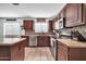 Eat-in kitchen with granite countertops and ample cabinet space at 20219 N 33Rd Pl, Phoenix, AZ 85050