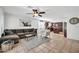 Living room with L-shaped sofa, tile floor, and kitchen view at 20219 N 33Rd Pl, Phoenix, AZ 85050