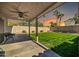 Covered patio with seating area and grassy backyard at 20219 N 33Rd Pl, Phoenix, AZ 85050