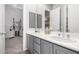 Bathroom with double sinks, gray cabinets, and a home gym at 20546 N 83Rd Pl, Scottsdale, AZ 85255