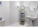 Stylish bathroom with pedestal sink, glass shelving, and mirror at 20546 N 83Rd Pl, Scottsdale, AZ 85255