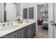 Bathroom with double sinks, gray cabinets, and bedroom view at 20546 N 83Rd Pl, Scottsdale, AZ 85255