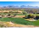 Aerial view of a lush green golf course with mountain backdrop at 20546 N 83Rd Pl, Scottsdale, AZ 85255