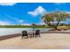 Relaxing lakeside patio furniture with scenic golf course views at 20546 N 83Rd Pl, Scottsdale, AZ 85255