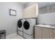 Laundry room with washer, dryer, cabinets, and sink at 20546 N 83Rd Pl, Scottsdale, AZ 85255