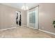 Dining room with view into kitchen, wood-look floors and large window at 2114 W Red Fox Rd, Phoenix, AZ 85085