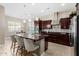 Spacious kitchen with island, stainless steel appliances, and dark wood cabinetry at 2114 W Red Fox Rd, Phoenix, AZ 85085