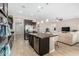 Modern kitchen with dark cabinets, island, and stainless steel appliances at 2114 W Red Fox Rd, Phoenix, AZ 85085