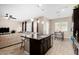 Modern kitchen with island, dark cabinets and stainless steel appliances at 2114 W Red Fox Rd, Phoenix, AZ 85085