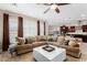 Living room with sectional sofa, coffee table and view into kitchen at 2114 W Red Fox Rd, Phoenix, AZ 85085