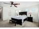 Main bedroom boasts king bed, ceiling fan, and ensuite bathroom access at 2114 W Red Fox Rd, Phoenix, AZ 85085