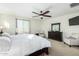 Main bedroom features a king bed, ceiling fan, and ample closet space at 2114 W Red Fox Rd, Phoenix, AZ 85085