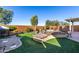 Landscaped backyard with a fire pit and seating area at 21268 N 266Th Ln, Buckeye, AZ 85396